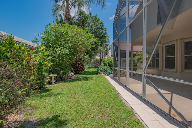 11481 Kanapali Ln, Boynton Beach, FL 33437 - view of grassy yard with a patio area and glass enclosure