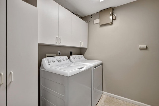 11481 Kanapali Ln, Boynton Beach, FL 33437 - washroom featuring cabinet space, baseboards, washing machine and dryer, and light tile patterned flooring