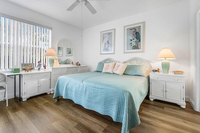 bedroom featuring a textured ceiling, hardwood / wood-style floors, and ceiling fan