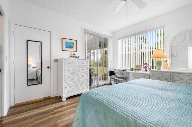 bedroom with dark wood-type flooring, access to outside, a textured ceiling, and ceiling fan