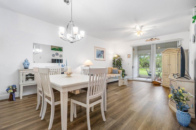 dining room featuring dark wood-type flooring, ceiling fan, and a textured ceiling