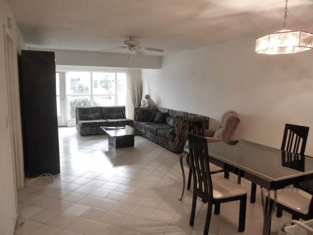 tiled dining space with ceiling fan