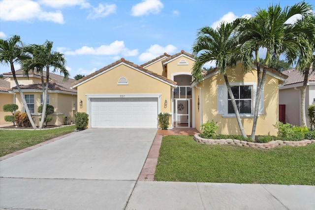 mediterranean / spanish-style house featuring a garage and a front yard