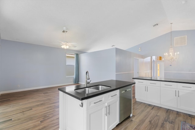 kitchen featuring wood-type flooring, vaulted ceiling, white cabinets, dishwasher, and sink