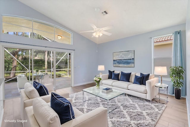 living room with ceiling fan, light hardwood / wood-style flooring, and vaulted ceiling