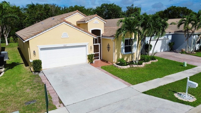 view of front of property featuring a garage and a front lawn