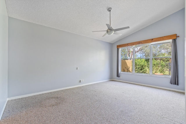 carpeted spare room with lofted ceiling, a textured ceiling, and ceiling fan