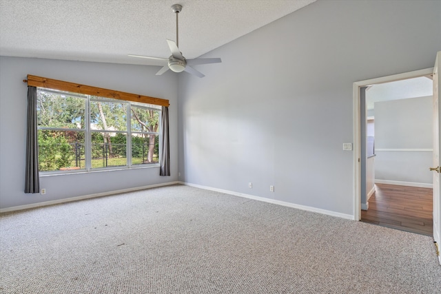 carpeted empty room featuring ceiling fan, a textured ceiling, and vaulted ceiling