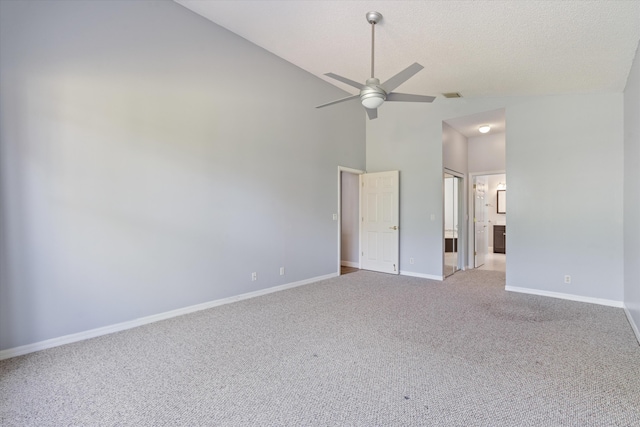 spare room with ceiling fan, carpet flooring, and high vaulted ceiling