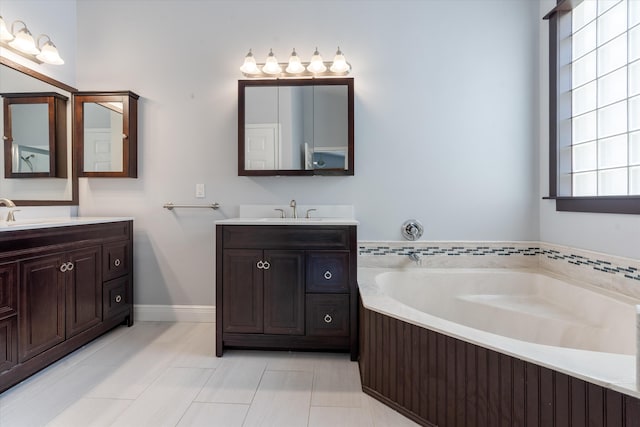 bathroom featuring a washtub, vanity, and tile patterned floors