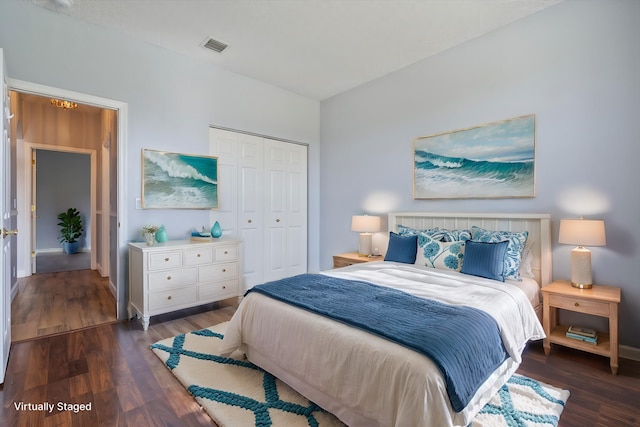 bedroom featuring dark hardwood / wood-style flooring and a closet