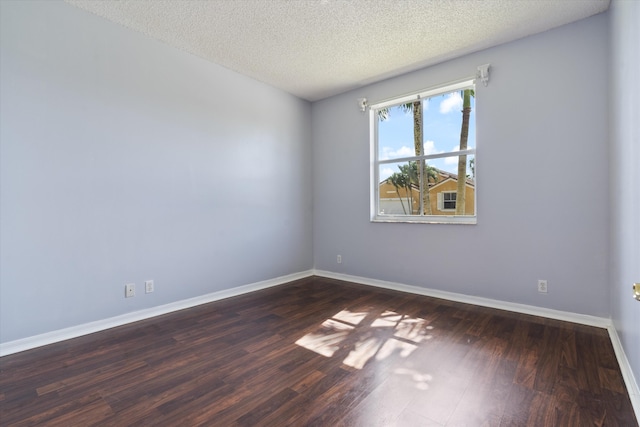 unfurnished room featuring dark hardwood / wood-style floors and a textured ceiling