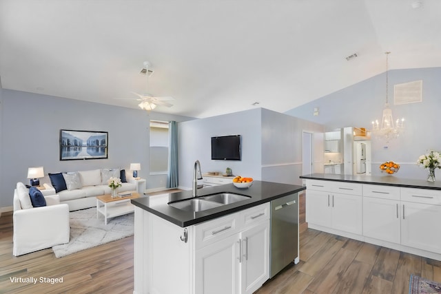 kitchen with white cabinetry, light wood-type flooring, an island with sink, dishwasher, and lofted ceiling