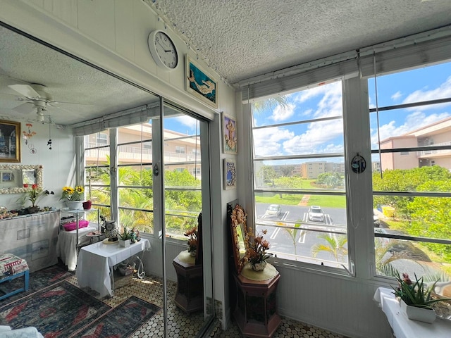 sunroom with plenty of natural light and ceiling fan