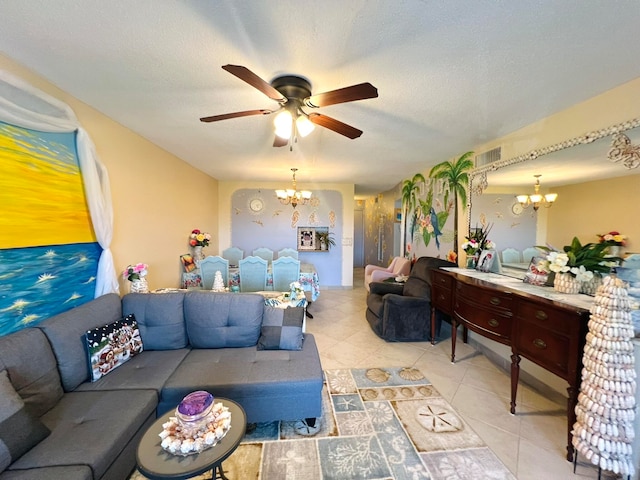 living room featuring a textured ceiling and ceiling fan with notable chandelier