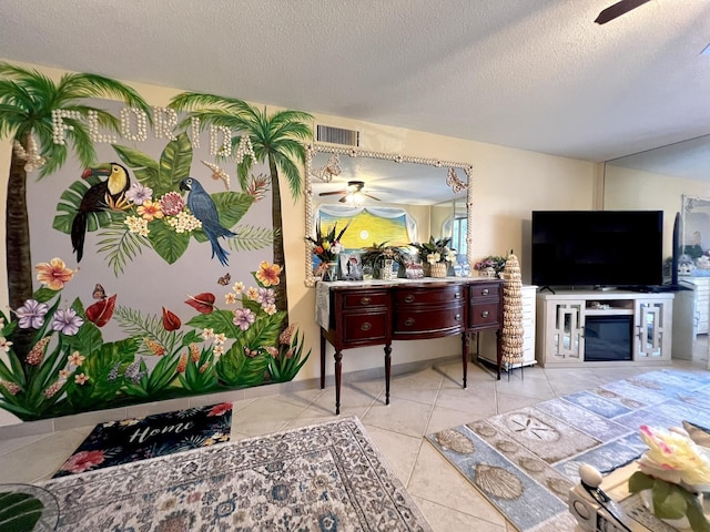 interior space with a textured ceiling and ceiling fan