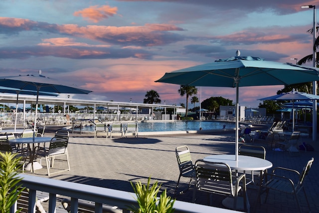 view of pool at dusk