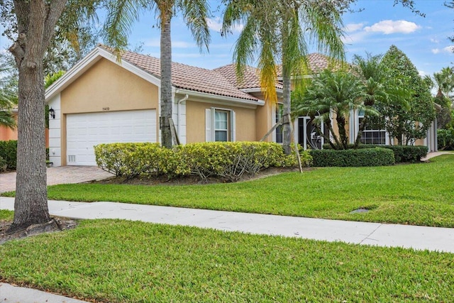 view of front facade with a front yard and a garage