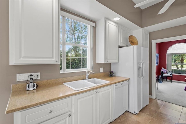 kitchen featuring white appliances, sink, a wealth of natural light, and white cabinets