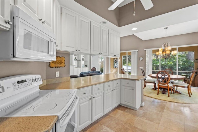 kitchen with kitchen peninsula, white cabinets, ceiling fan with notable chandelier, decorative light fixtures, and white appliances