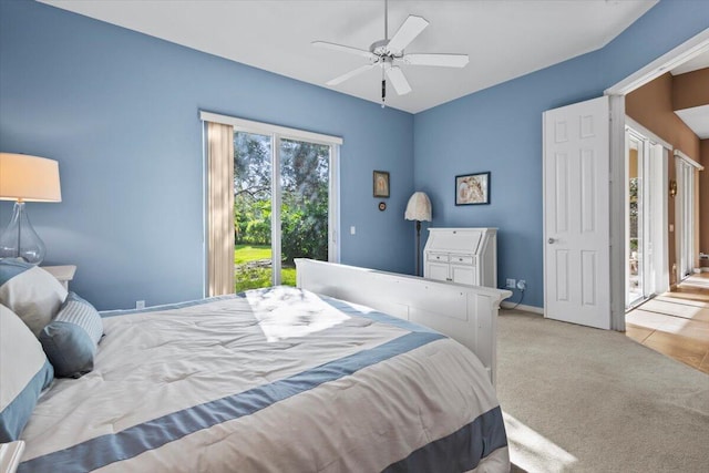 bedroom with light carpet, access to exterior, and ceiling fan