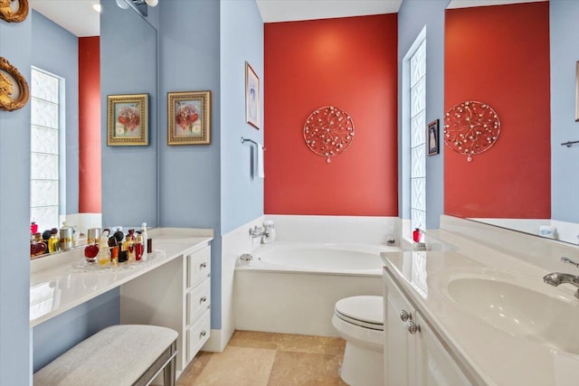 bathroom with toilet, a bathing tub, and vanity