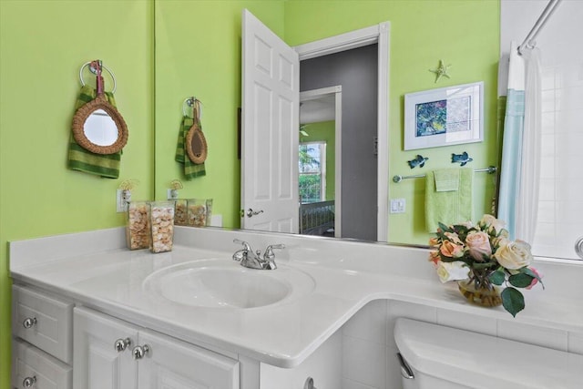 bathroom featuring vanity, toilet, and a shower with shower curtain