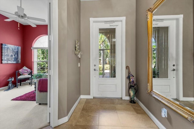 entryway with tile patterned flooring, a healthy amount of sunlight, and ceiling fan