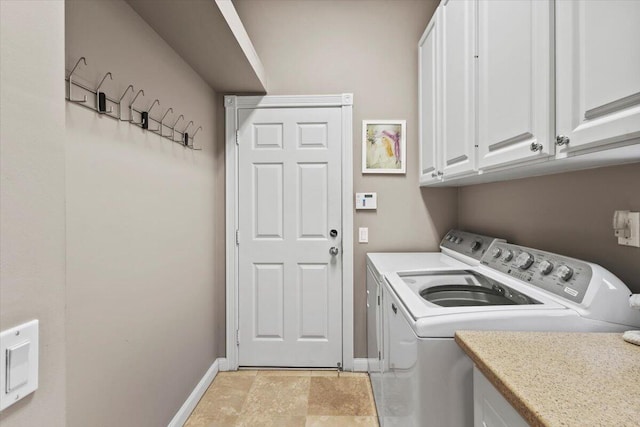 washroom featuring cabinets and washer and dryer