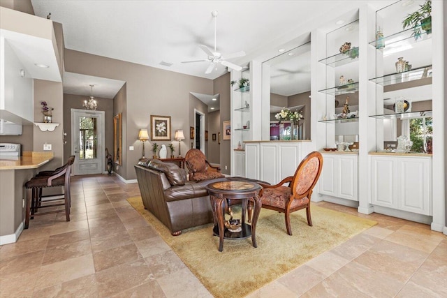 living room featuring ceiling fan with notable chandelier