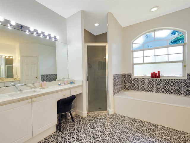 bathroom featuring tile patterned flooring, vanity, and separate shower and tub