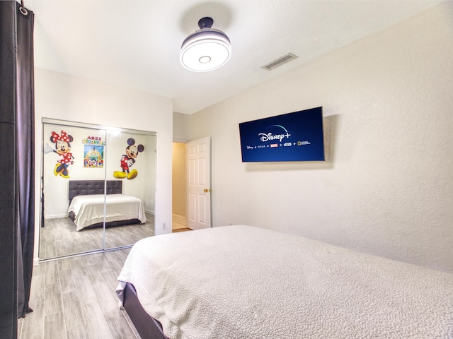 bedroom featuring light hardwood / wood-style flooring and a closet