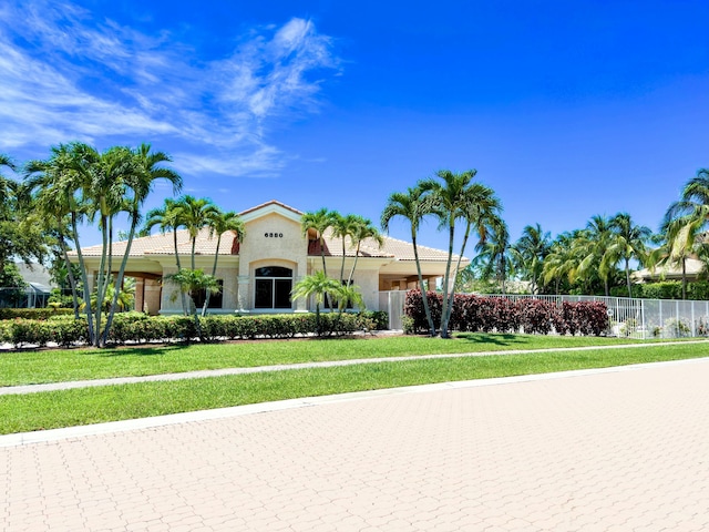 mediterranean / spanish-style house featuring a front yard