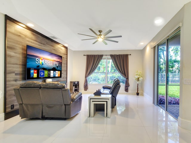 tiled living room featuring ceiling fan