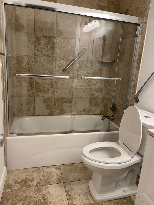 full bathroom with vanity, bath / shower combo with glass door, and toilet