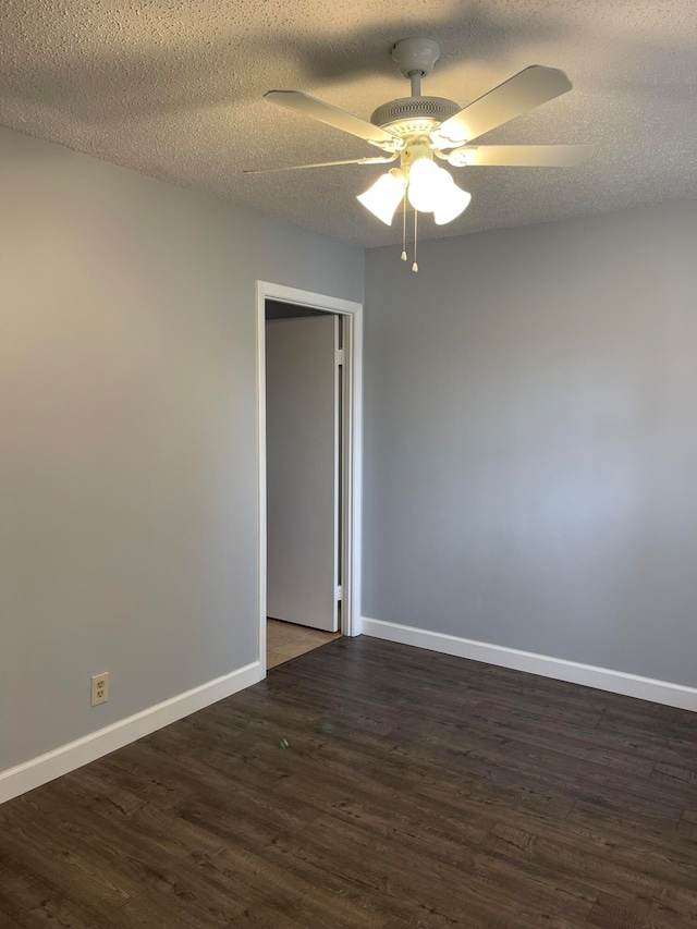 unfurnished room featuring ceiling fan, a textured ceiling, and dark hardwood / wood-style flooring