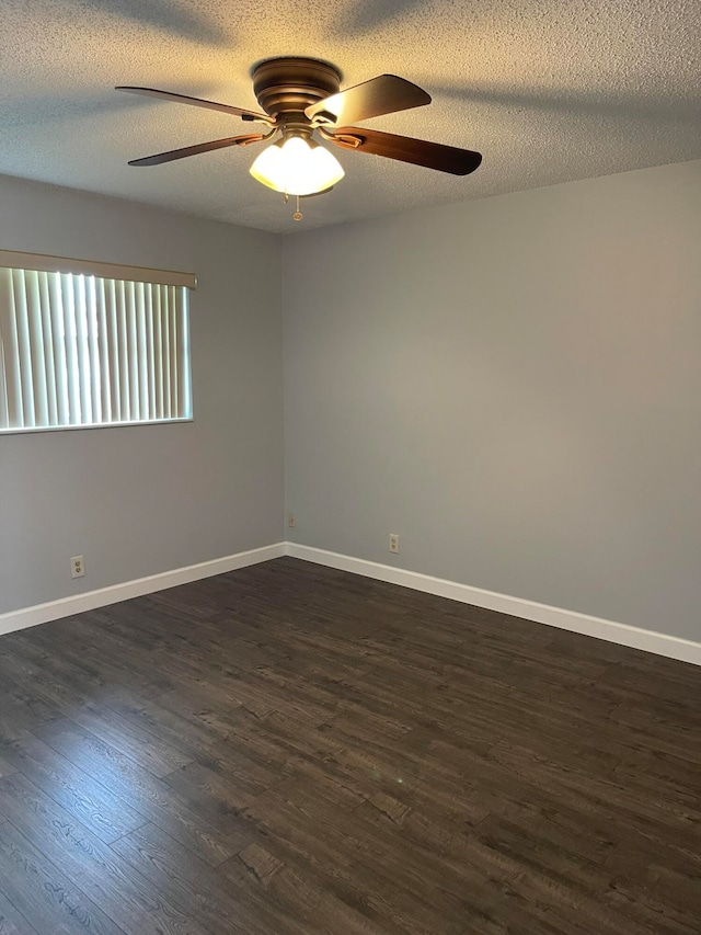 spare room featuring ceiling fan, a textured ceiling, and dark hardwood / wood-style floors