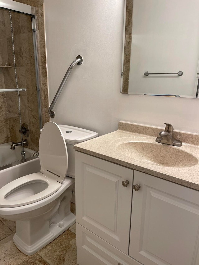 full bathroom with vanity, toilet, tile patterned floors, and shower / bath combination with glass door