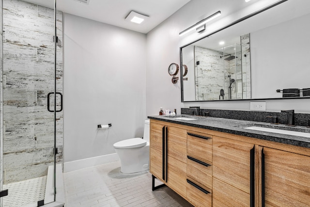 bathroom featuring vanity, tile patterned flooring, toilet, and an enclosed shower