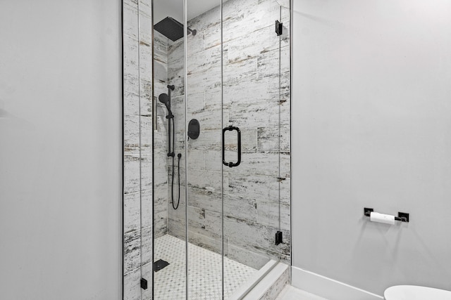 bathroom featuring walk in shower and toilet