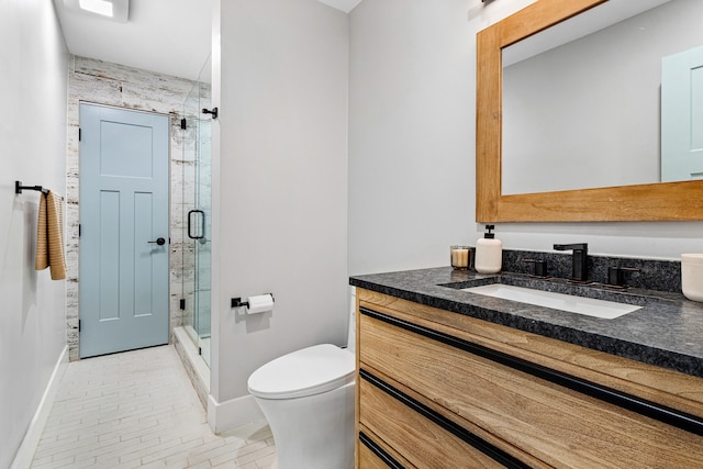 bathroom with an enclosed shower, vanity, and toilet