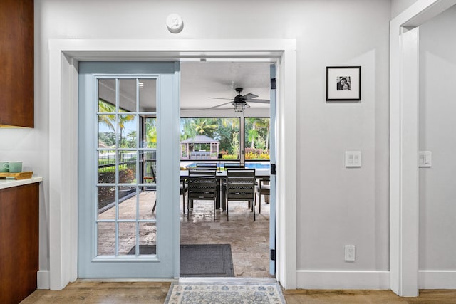 doorway to outside featuring light hardwood / wood-style floors and ceiling fan