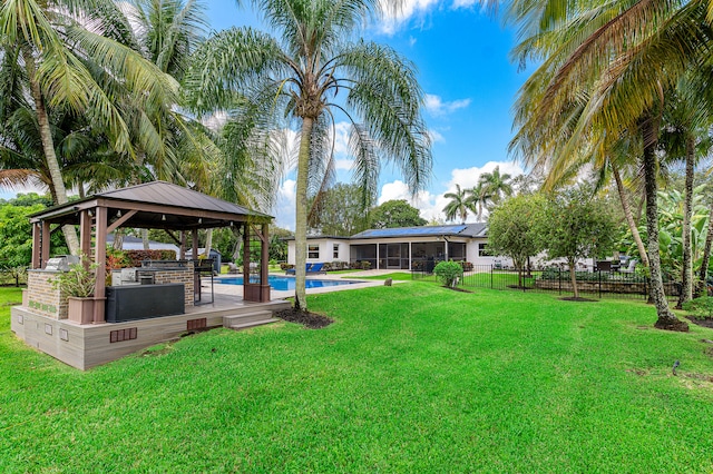 view of yard featuring a fenced in pool and a gazebo