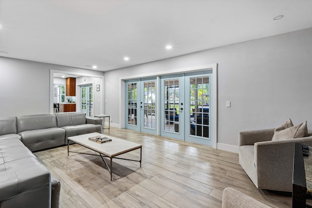 living room with french doors and light wood-type flooring