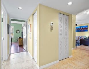 hall featuring light tile patterned flooring