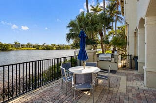 view of patio featuring a water view and a balcony