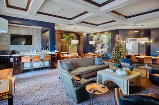 carpeted living room featuring beam ceiling, crown molding, and coffered ceiling