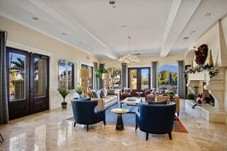 living room featuring beamed ceiling, french doors, ceiling fan, and crown molding