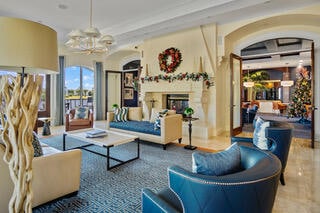 living room with ornamental molding and a chandelier