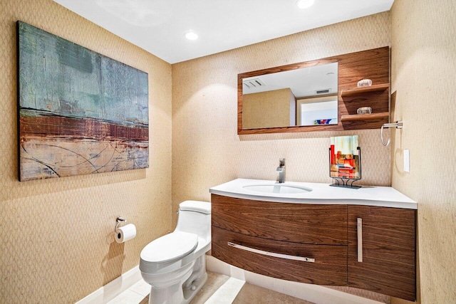 bathroom featuring tile patterned flooring, vanity, and toilet